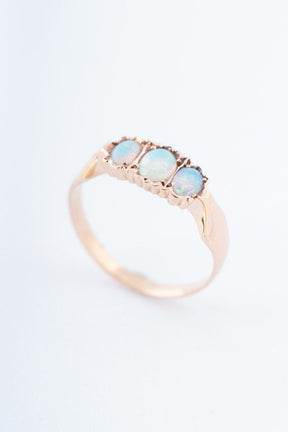 Gold row ring with 3 opals