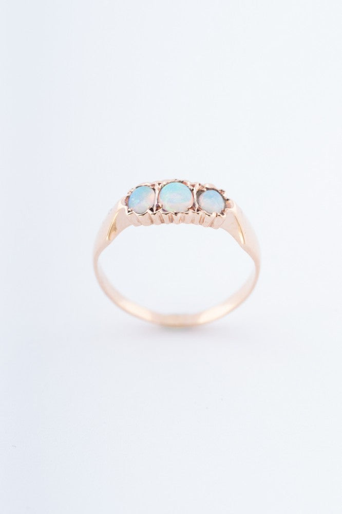 Gold row ring with 3 opals