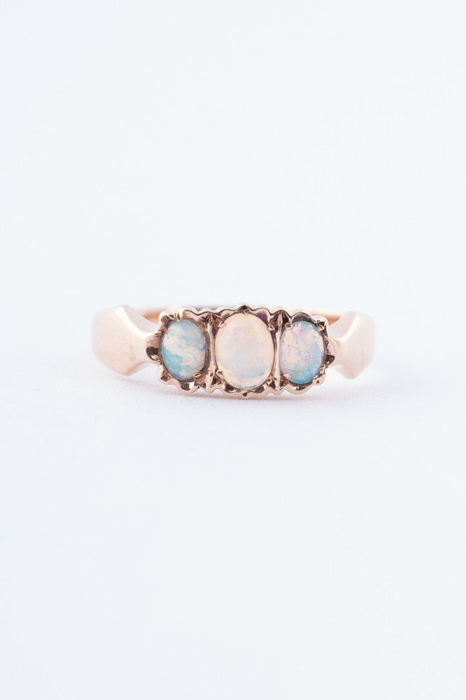 Gold row ring with 3 opals