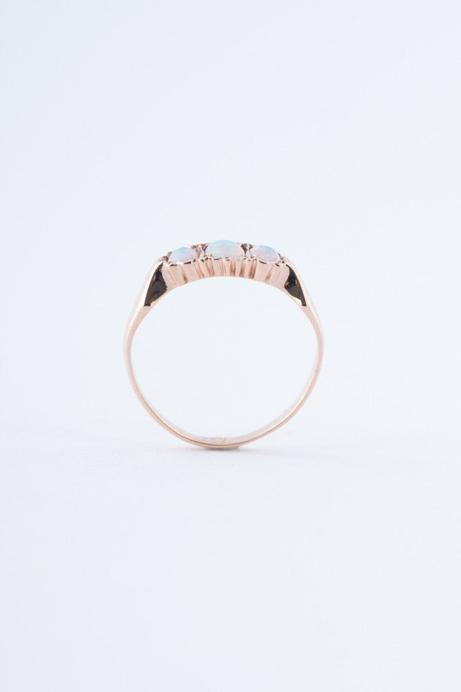 Gold row ring with 3 opals