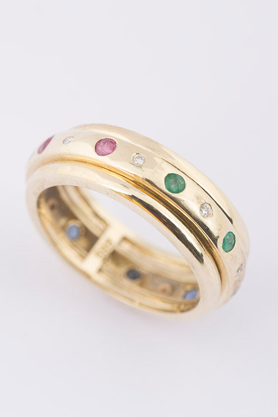 Gold alliance (eternity) ring with various gemstones