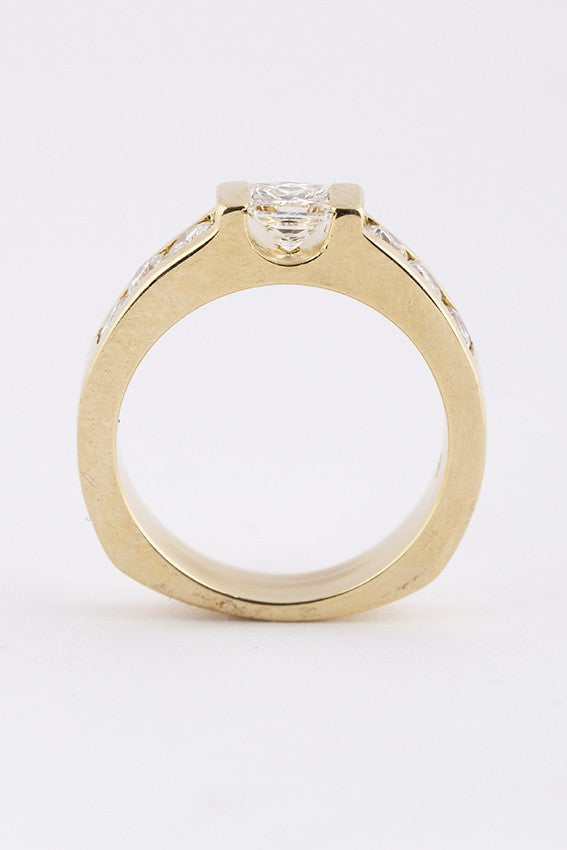 Gold band ring with a princess cut round diamonds