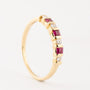 Gold row ring with brilliant and ruby