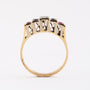 Gold row ring with a brilliant, sapphires and rubies