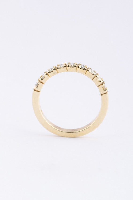 Gold row ring with 9 diamonds