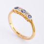 Gold row ring with 3 sapphires and 2 brilliants set in platinum