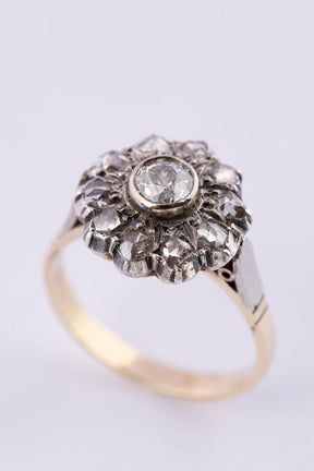 Gold entourage ring with an old-cut brilliant and rose-cut diamonds.