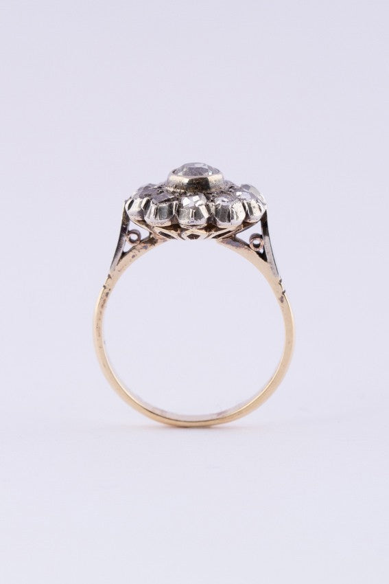 Gold entourage ring with an old-cut brilliant and rose-cut diamonds.