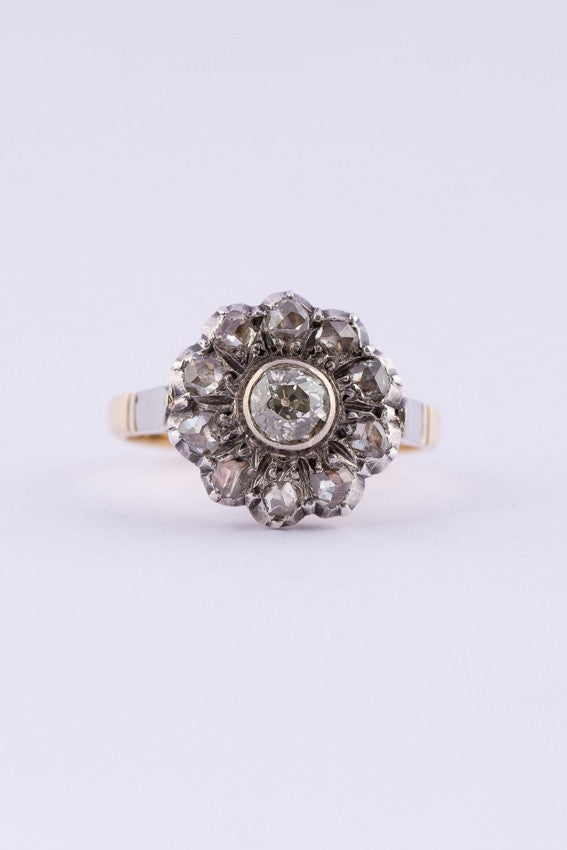 Gold entourage ring with an old-cut brilliant and rose-cut diamonds.