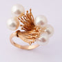 Golden artistic ring with cultured pearls