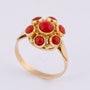 Gold entourage ring with blood corals
