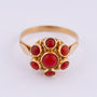Gold entourage ring with blood corals