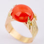Gold ring with a cabochon-cut blood coral