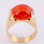 Gold ring with a cabochon-cut blood coral