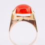 Gold ring with a cabochon-cut blood coral
