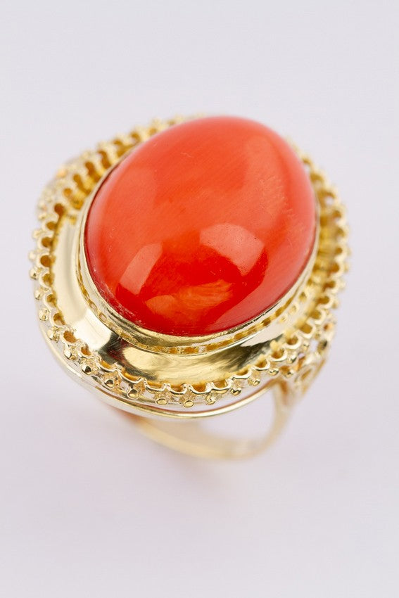 Gold ring with large cabochon cut blood coral
