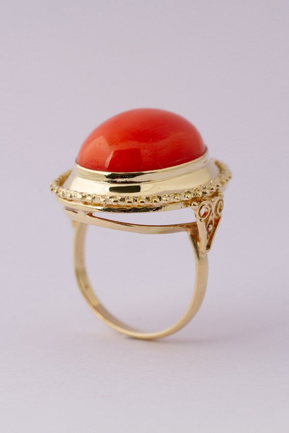 Gold ring with large cabochon cut blood coral
