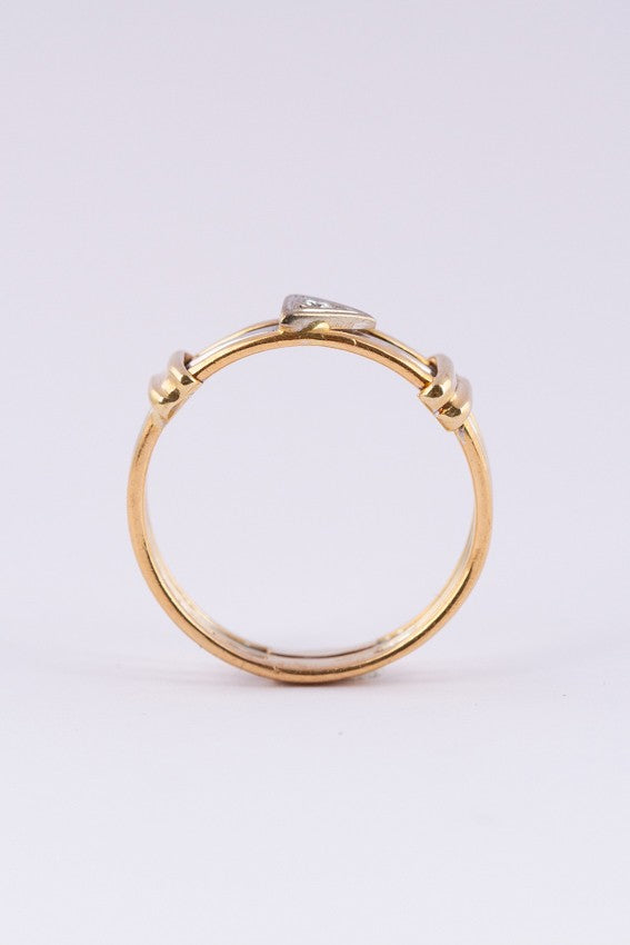 Wit/geel gouden spangen ring met een briljant