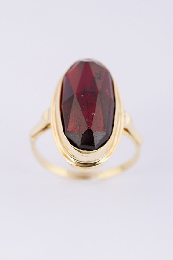 Gold ring with faceted garnet