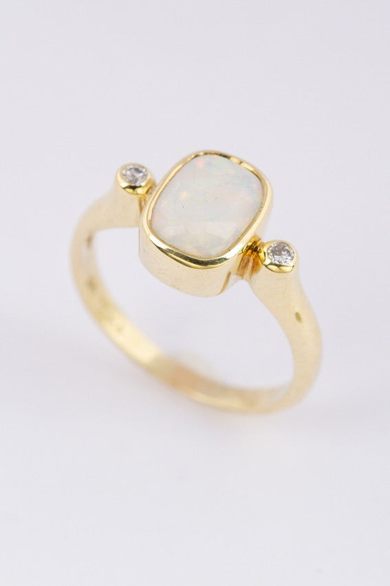 Gold ring with milk opal and diamonds