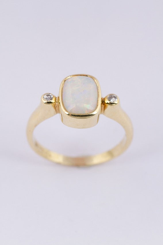 Gold ring with milk opal and diamonds
