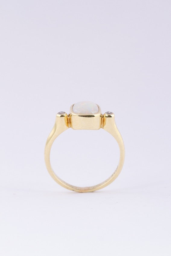 Gold ring with milk opal and diamonds