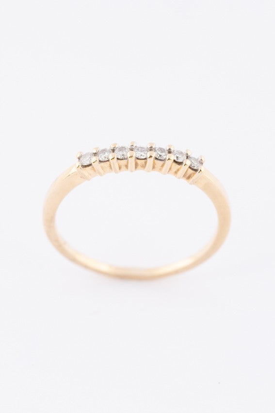Gold row ring with 7 diamonds