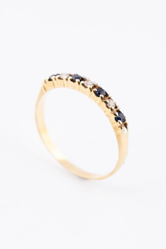 Gold row ring with diamonds and sapphires