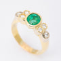 Gold ring with an emerald and 6 diamonds
