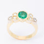 Gold ring with an emerald and 6 diamonds