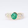 Gold ring with an emerald and 6 diamonds