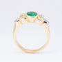 Gold ring with an emerald and 6 diamonds