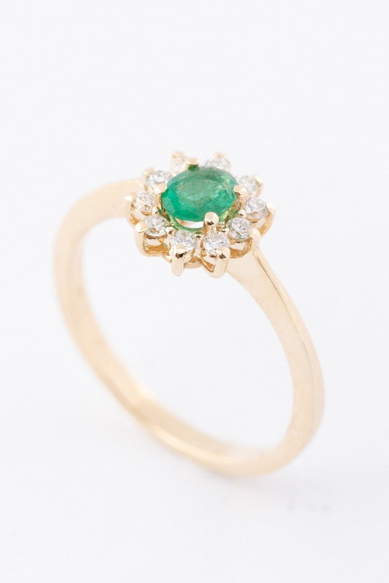Gold entourage ring with emerald and diamonds