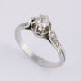 Platinum solitaire ring with a brilliant and diamonds