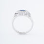 White gold entourage ring with a cushion sapphire and diamonds