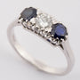 White gold row ring with brilliant and sapphires
