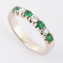 White gold row ring with emerald and brilliant