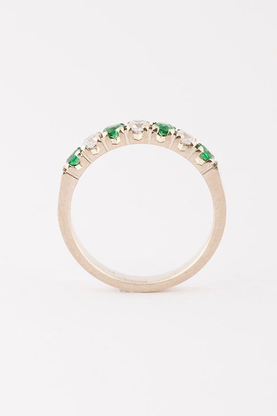 White gold row ring with emerald and brilliant