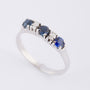 Row ring with sapphire and brilliant