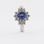 White gold entourage ring with sapphire and brilliant