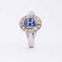 White gold entourage ring with sapphire and diamonds