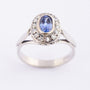 White gold entourage ring with sapphire and diamonds