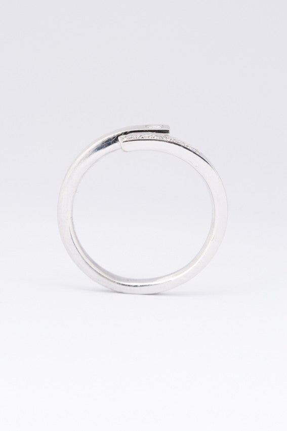 Wit gouden gematteerde slag ring met een prinses geslepen briljant van en rond geslepen briljanten