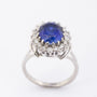 White gold entourage ring with sapphire and diamonds