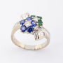 White gold bow ring with sapphire, emerald and diamonds