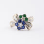 White gold bow ring with sapphire, emerald and diamonds