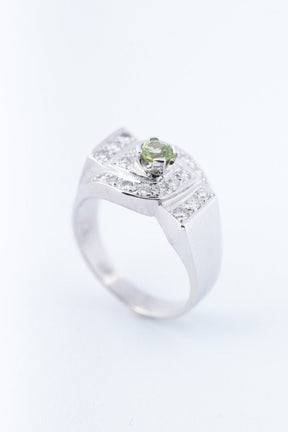 White block ring with a peridot and diamonds