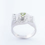 White block ring with a peridot and diamonds