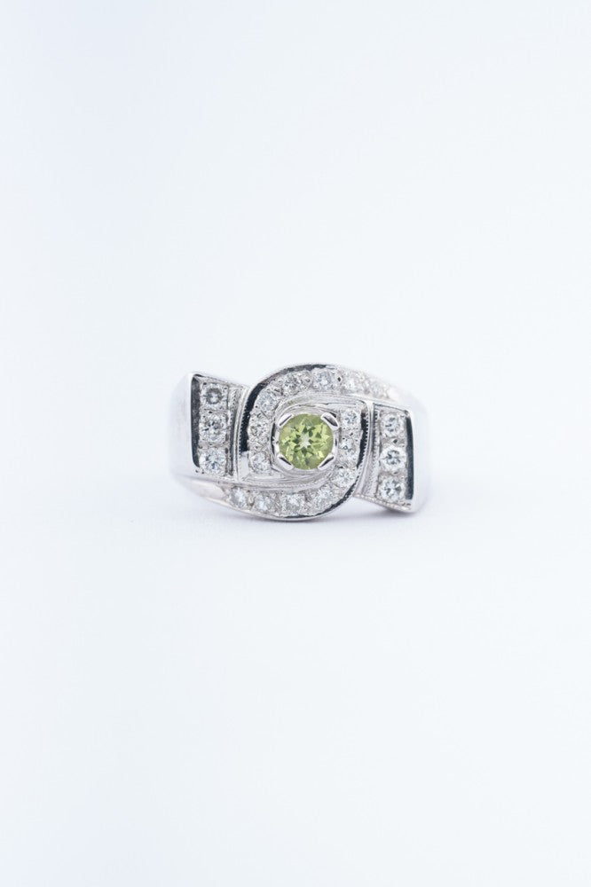 White block ring with a peridot and diamonds